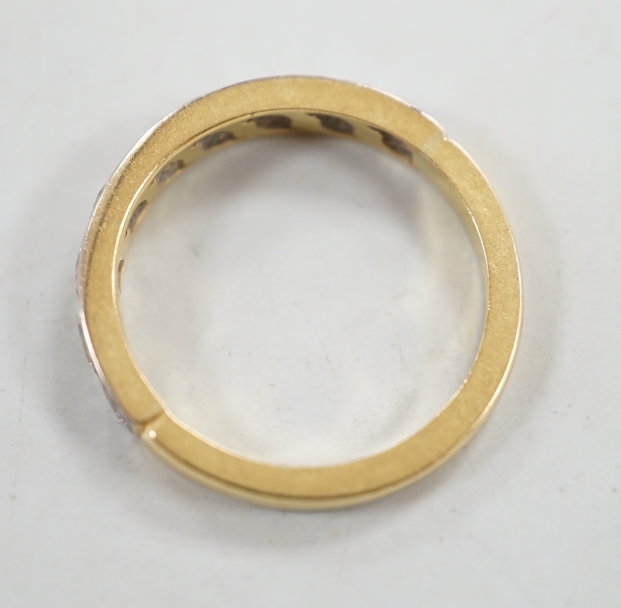 An 18ct and nine stone diamond set half eternity ring, size M, gross weight 3.5 grams.